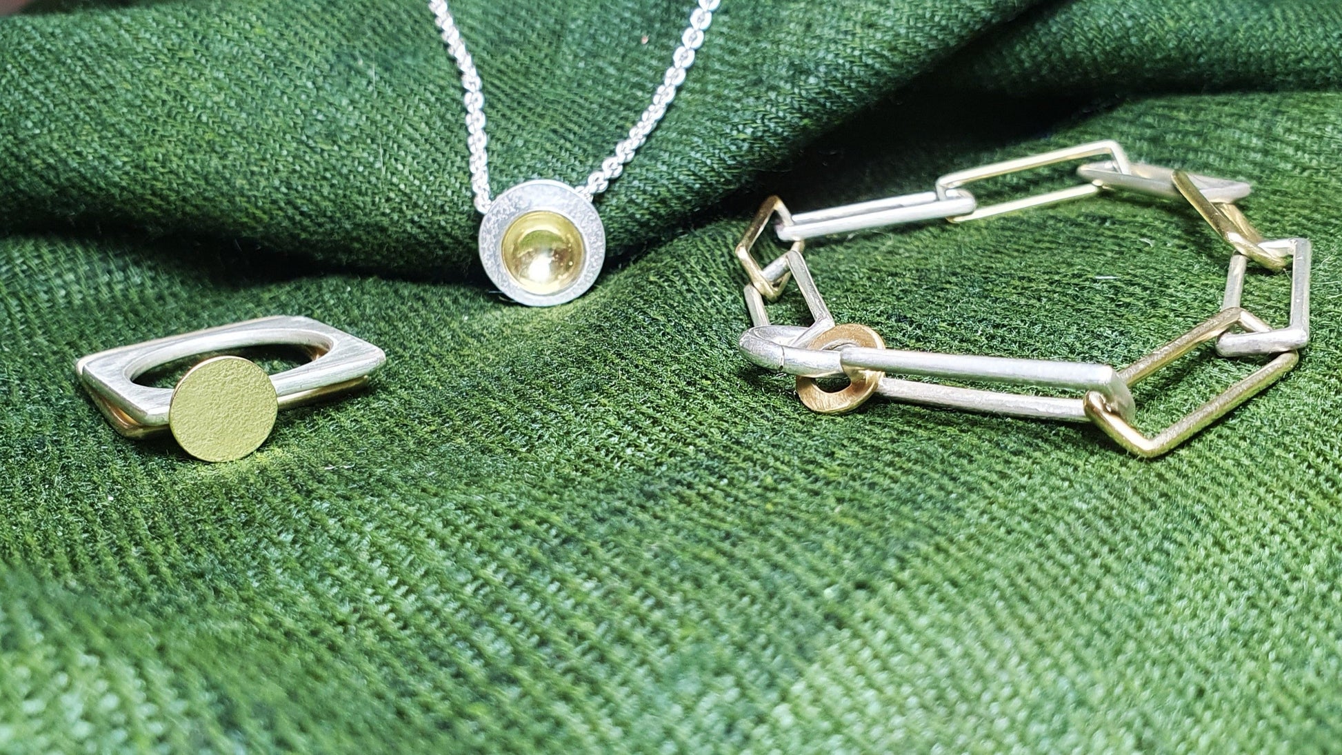 Silver and gold jewellery featuring: Orbit pendant, silver with gold cup; square ring with gold moon; and, orbit bracelet #BarbaraSpenceJewellery 